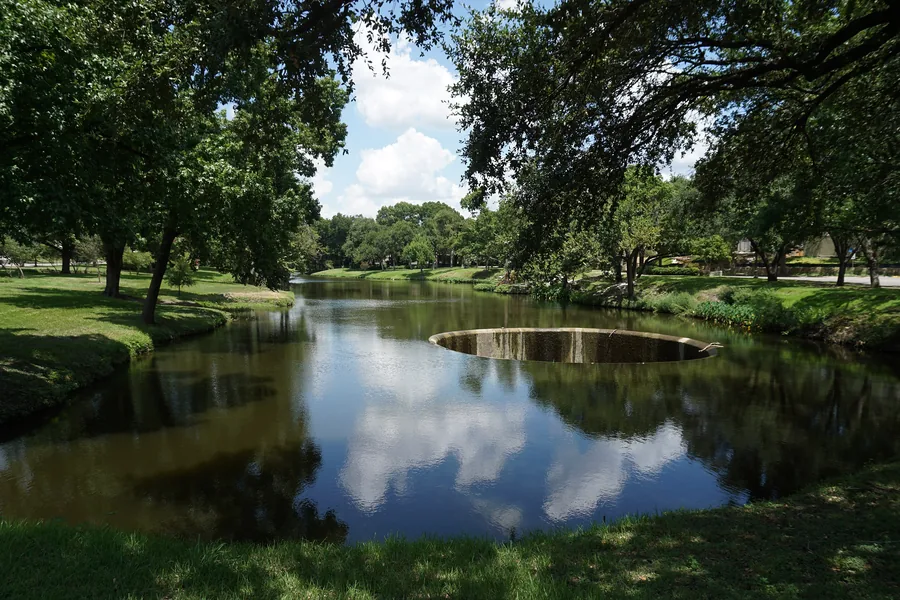 Clouds reflected in the water at Lakeside Park in Highland Park, Texas