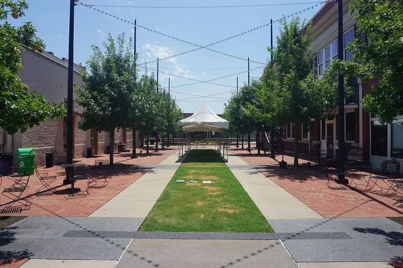 Tree lined Wayne Ferguson Plaza in Old Town Lewisville, Texas