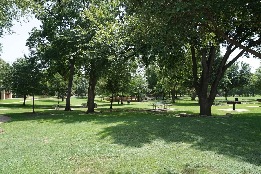 Shaded lawns and mature trees at Curtis Park in University Park, Texas